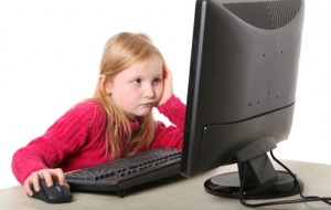 girl looking at computer monitor