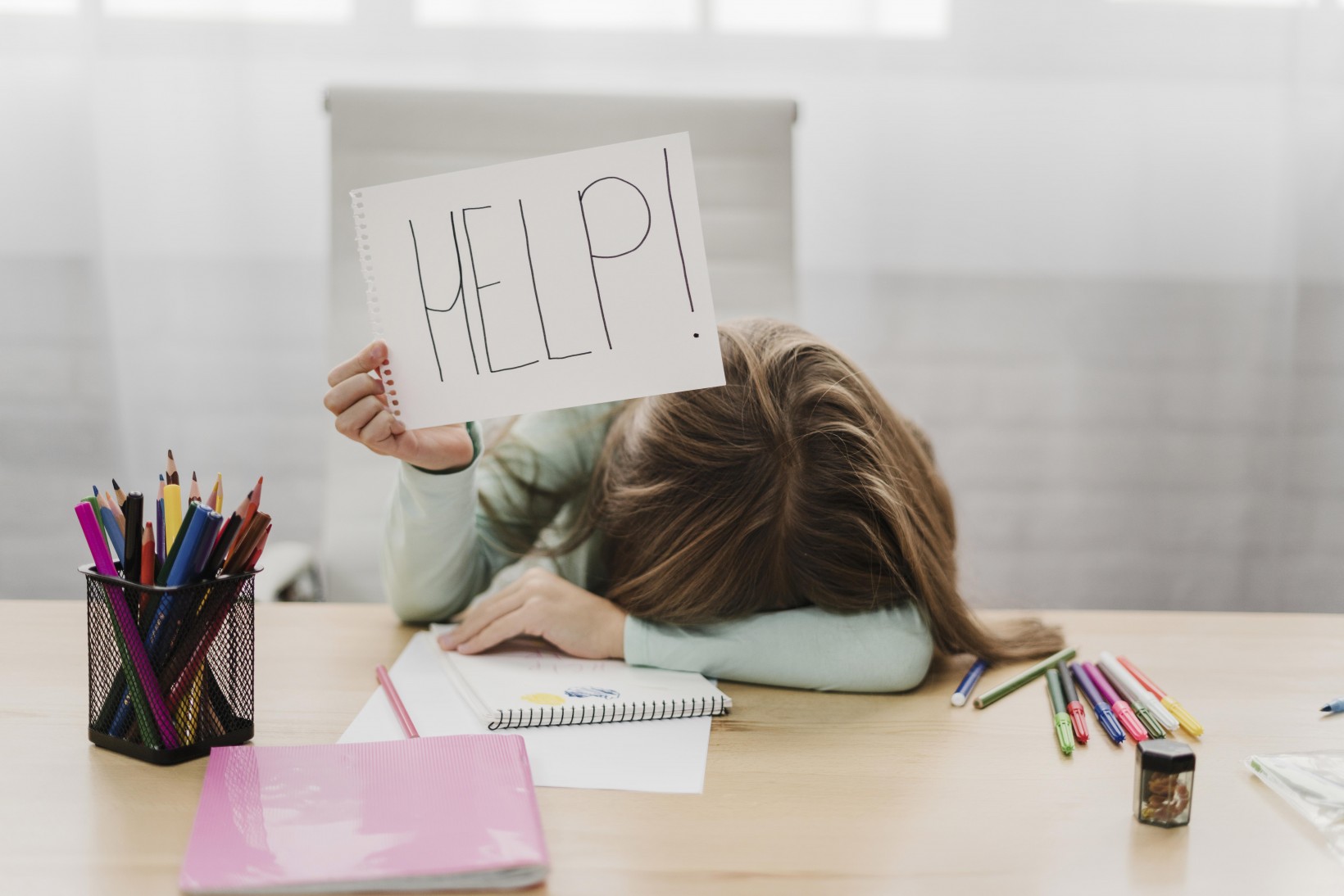 little girl holding help message white paper