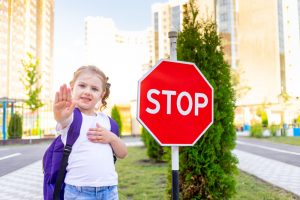 schoolgirl girl with stop sign crosses road learns rules road