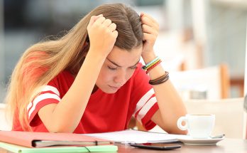 Frustrated student trying to understand notes in a bar