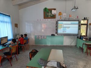 students use computer and interactive board for coding activity