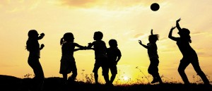 Silhouette, group of happy children playing on meadow, sunset, s