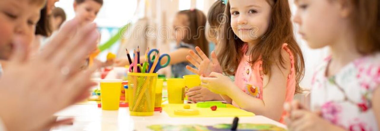 cropped kindergarten kids doing arts crafts teacher day care centre children 148142355